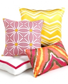 An embroidered modern tile pattern in bold pink with bright yellow accents embellishes this decorative pillow from Trina Turk.