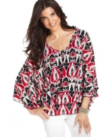 Go with the flow: Style&co.'s draped peplum petite tunic gives any outfit an elegant upgrade.