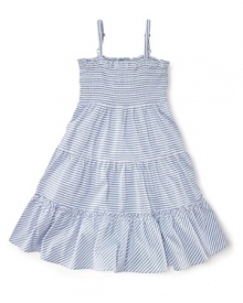 A stylish striped jersey dress is updated with smocked detailing and a pretty, flared silhouette.