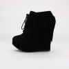 Show up in style with these trendy fringe wedge booties. Features a round toe, synthetic suede upper, fringe detail, front lace closure, 1.5"  platform and 5.5"  heel. Imported.