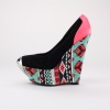 Step up to a fashionable world in these trendy platform wedges. Features a synthetic suede & leather upper with a tribal print textile covered balance and metal toe ornament. Measures with a 1.75"  platform and 6"  heel. Imported.