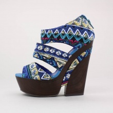 Step out in these trendy tribal printed platform wedges. Features a printed fabric upper with rear zip closure atop a simulated wood balance with a 1.5"  platform & 5.5"  heel. Imported.