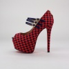 Stand tall and stand out in these chic platform heels. Features a houndstooth pattern fabric upper with leather straps, peep toe and rear zipper closure with heart shaped charm. Measures a 2.5"  hidden platform & 6"  heel height. Imported.