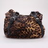 This safari-inspired shoulder bag packs a playful style punch