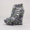 This fun sporty wedge bootie is perfect for summer. Features a floral printed fabric upper with cutouts, lace-up closure, 1"  platform & 5"  heel. Imported.