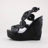 Step out in the streets with this stylish platform wedge. Features intricate cut-out designs with adjustable slingback strap. Covered 1.5"  platform and 5"  heel. Constructed from man-made materials. Imported.