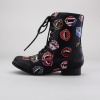 With 'Bite Me!' printed across the toes of these boots you will surely make a statement. These women's combat style boots feature a synthetic leather upper with printed lip graphics and a side zipper closure. Finished with a 1.5"  heel. Imported.